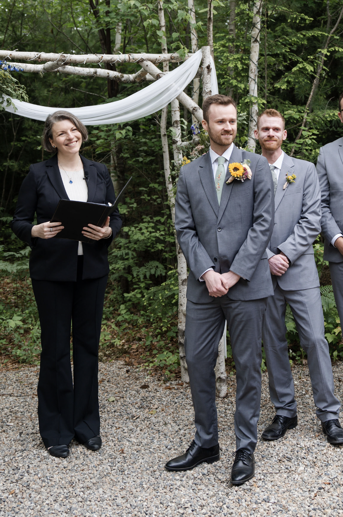 Bride and groom embracing during a waterfront ceremony